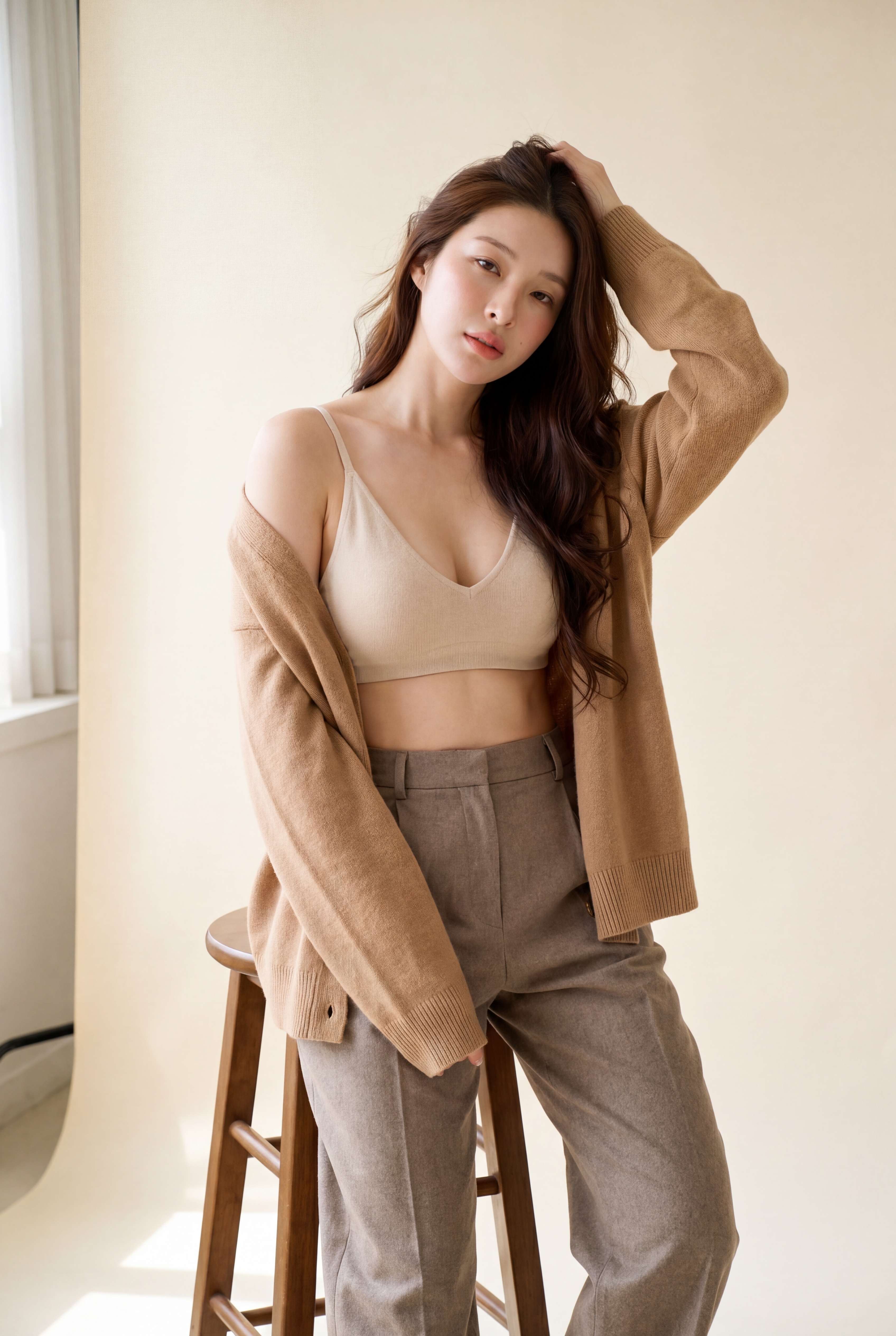 Mila — hand in hair, leaning against stool